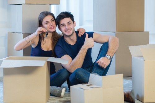 Movers carrying furniture through a narrow hallway in a Barnes property