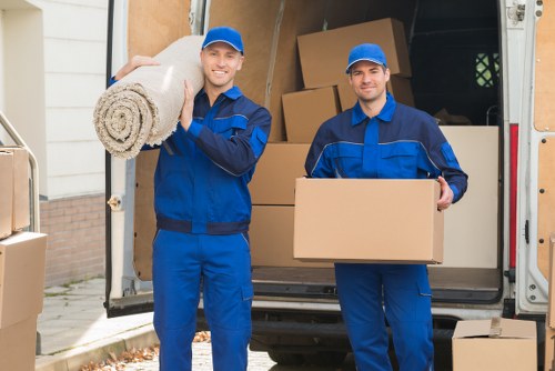 Furniture removals team handling a sofa move in Barnes