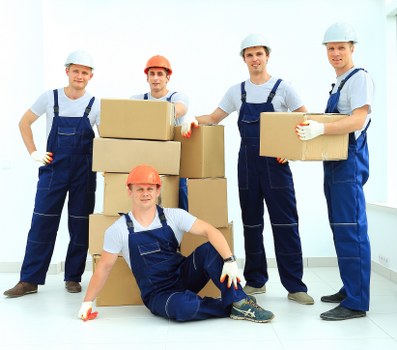 Professional piano movers delivering an instrument into a Barnes home