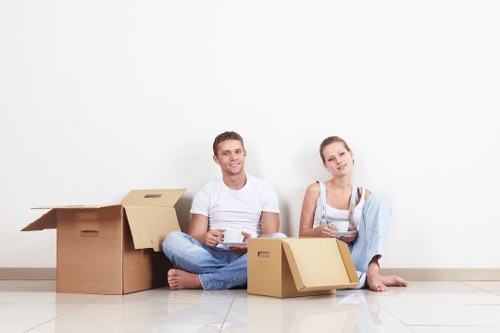 Professional movers transporting household items through a Barnes residential street