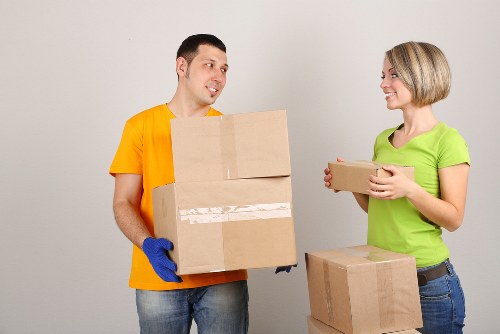 Packed household boxes and wrapped furniture prepared for removals in Barnes